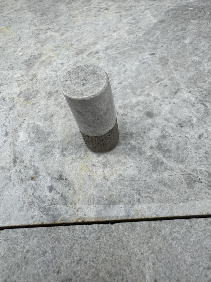 A travertine core removed while drilling an anchor hole.